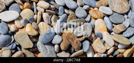 Sea stone pebble background. Abstract nature background with pebble stones. Full frame shot of multicolored pebbles. Close-up. Top view Stock Photo