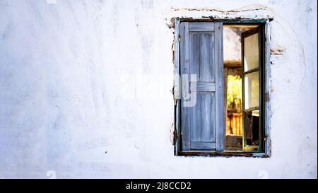 Banner of an Antique window on a white old wall and  light from an inside window. Stock Photo