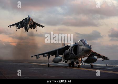 U.S. Marine Corps AV-8B Harrier fighter jets attached to the Tigers of Marine Attack Squadron 542, perform vertical landings on the flight deck of the Wasp-class amphibious assault ship USS Kearsarge, September 23, 2021 operating on the Atlantic Ocean. Stock Photo