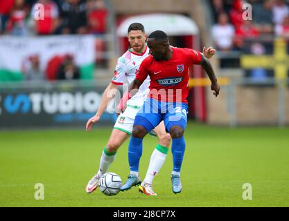 Dagenham and Redbridge's Junior Morias (right) and Wrexham's Ben Tozer battle for the ball during the Vanarama National League match at the Chigwell Construction Stadium, London. Picture date: Sunday May 15, 2022. Stock Photo