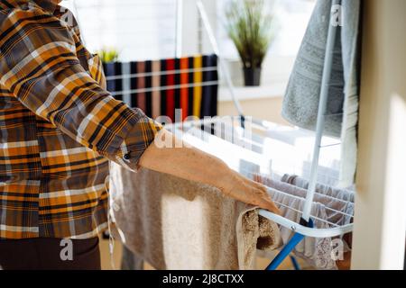 Woman hand washing and hanging up laundry outdoor in a sunny day. Woman  holding a tin bucket of water. Retro style Stock Photo - Alamy