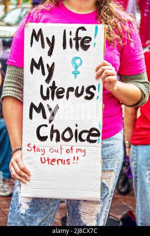 Unidentifiable young woman holding sign at pro choice rally reading my life my uterus my choice Stock Photo