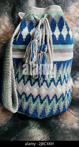Handmade bags. Knitted from colored threads. Volumetric and comfortable to wear with a long handle. Crochet and knitting. Stock Photo