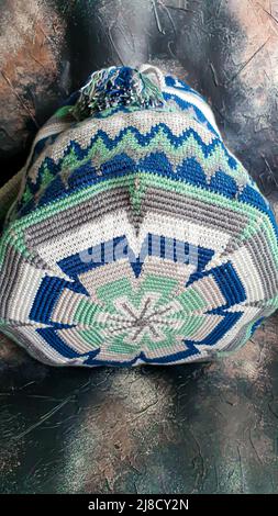 Handmade bags. Knitted from colored threads. Volumetric and comfortable to wear with a long handle. Crochet and knitting. Stock Photo