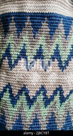 Handmade bags. Knitted from colored threads. Volumetric and comfortable to wear with a long handle. Crochet and knitting. Stock Photo