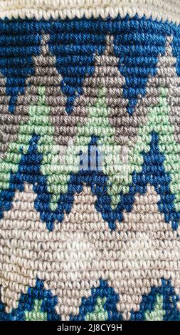 Handmade bags. Knitted from colored threads. Volumetric and comfortable to wear with a long handle. Crochet and knitting. Stock Photo