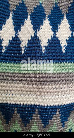 Handmade bags. Knitted from colored threads. Volumetric and comfortable to wear with a long handle. Crochet and knitting. Stock Photo