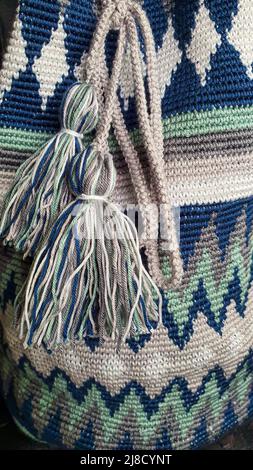 Handmade bags. Knitted from colored threads. Volumetric and comfortable to wear with a long handle. Crochet and knitting. Stock Photo
