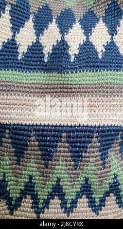 Handmade bags. Knitted from colored threads. Volumetric and comfortable to wear with a long handle. Crochet and knitting. Stock Photo