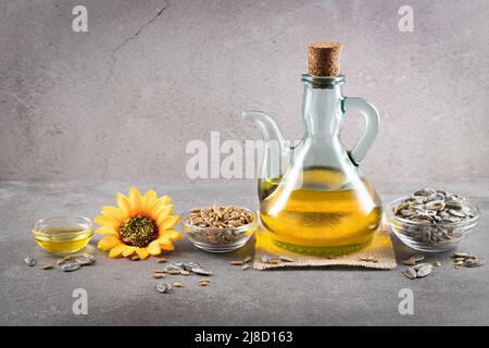 Sunflower oil and sunflower seeds on dark concrete background with copyspace. Stock Photo