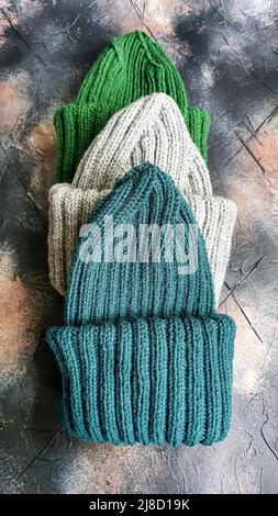 Handmade balaclava with Ukrainian symbols. Knitted from gray and green threads. Warms, reliably saves from the cold. Crochet and knitting. Stock Photo
