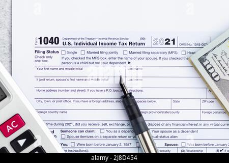 Flat lay of Individual income tax return form for tax payment on working desk. Background for Data analysis, paperwork, financial research, report Stock Photo