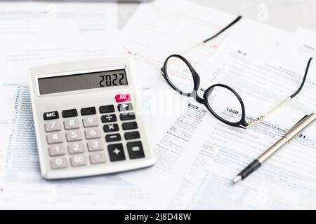 Flat lay of Individual income tax return form for tax payment on working desk. Background for Data analysis, paperwork, financial research, report Stock Photo