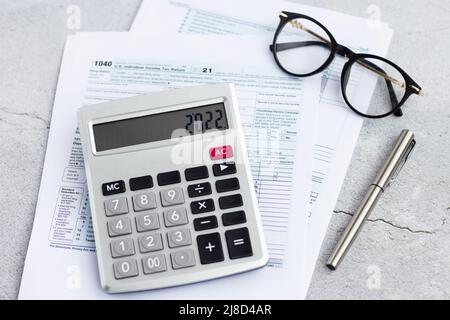 Flat lay of Individual income tax return form for tax payment on working desk. Background for Data analysis, paperwork, financial research, report Stock Photo