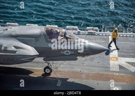 A U.S. Marine Corps F-35B Lightning II fighter aircraft, attached to the Wake Island Avengers of Marine Attack Squadron 211, prepares to take off from the flight deck of the Wasp-class amphibious assault ship USS Essex, March 24, 2021 operating on the Pacific Ocean. Stock Photo