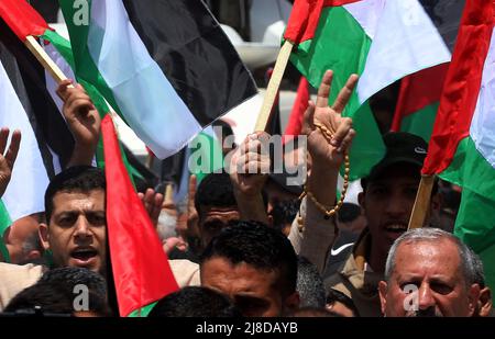 Gaza City. 15th May, 2022. Palestinians wave their national flags during a rally marking the 74h anniversary of what the Palestinians call the 'Nakba,' or  Israel's 1948 creation, in front of the UNESCO offices in Gaza City,  on Sunday, May 15, 2022. 'Nakba' means in Arabic 'catastrophe' in reference to the birth of the state of Israel 74-years-ago in British-mandate Palestine, which led to the displacement of hundreds of thousands of Palestinians who either fled or were driven out of their homes during the 1948 war over Israel's creation.     Photo by Ismael Mohamad/UPI Credit: UPI/Alamy Live Stock Photo