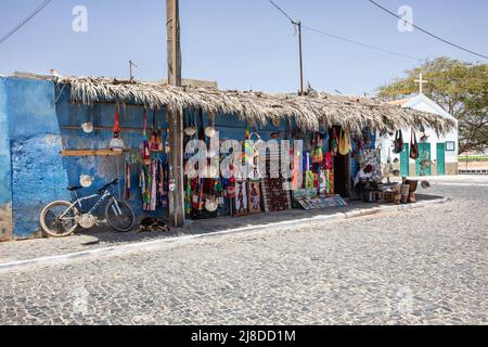 Tradional shop selling souvenirs with Capela de Sao Jose church in the background, Palmeira, Sal, Cape Verde Islands, Africa Stock Photo