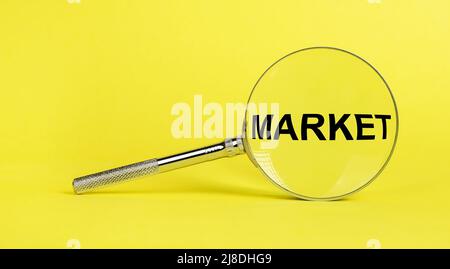 Target market research. Magnifying glass with text on yellow background. Gathering and analysis of information about new product, consumers opinion. Marketing concept. High quality photo Stock Photo