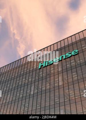 Qingdao, China, USA. May 2, 2022. Editorial Use Only, 3D CGI. Hisense Signage Logo on Top of Glass Building. Workplace of Electronics Company Office H Stock Photo