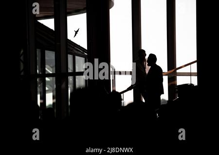 Duesseldorf, Germany. 15th May, 2022. People stand in the state parliament and look at the current projections. In North Rhine-Westphalia, the election for the 18th state parliament takes place on Sunday. Credit: Fabian Strauch/dpa/Alamy Live News Stock Photo