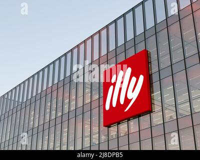Trieste, Italy. May 2, 2022. Editorial Use Only, 3D CGI. Illy Corporation Signage Logo on Top of Glass Building. Workplace Coffee Company Office Stock Photo