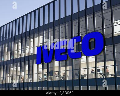 Turin, Italy. May 2, 2022. Editorial Use Only, 3D CGI. Iveco Signage Logo on Top of Glass Building. Workplace of Vehicle Manufacturer Company Office H Stock Photo