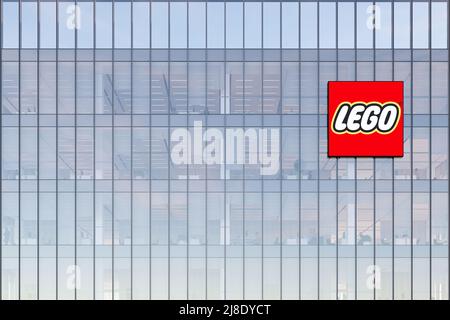 Billund, Denmark. May 2, 2022. Editorial Use Only, 3D CGI. The Lego Group Signage Logo on Top of Glass Building. Workplace Toy Company Office Headquar Stock Photo