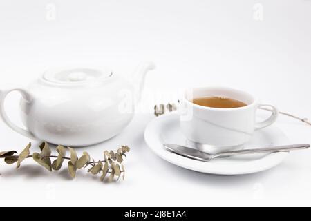 white tea set with teapot tea and saucers and pie for breakfast Stock Photo
