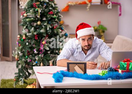 Young man celebrating New year at home alone Stock Photo