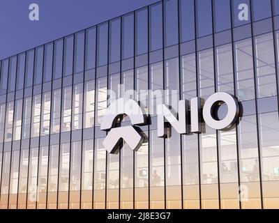 Shanghai, China. May 2, 2022. Editorial Use Only, 3D CGI. NIO Company Signage Logo on Top of Glass Building. Workplace Electric Vehicles Automaker Off Stock Photo