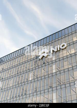 Shanghai, China. May 2, 2022. Editorial Use Only, 3D CGI. NIO Company Signage Logo on Top of Glass Building. Workplace Electric Vehicles Automaker Off Stock Photo