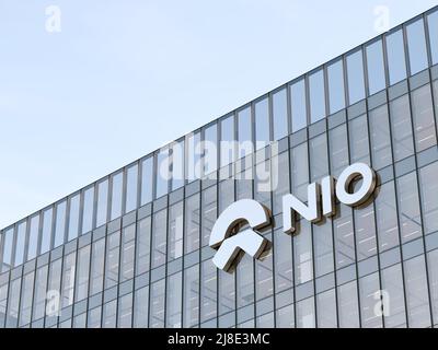 Shanghai, China. May 2, 2022. Editorial Use Only, 3D CGI. NIO Company Signage Logo on Top of Glass Building. Workplace Electric Vehicles Automaker Off Stock Photo