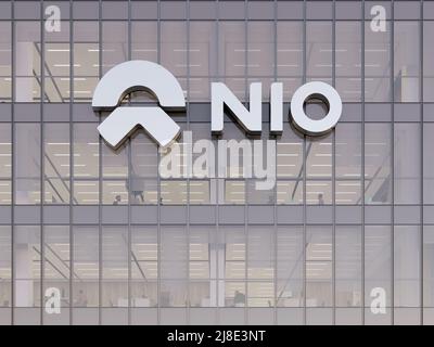 Shanghai, China. May 2, 2022. Editorial Use Only, 3D CGI. NIO Company Signage Logo on Top of Glass Building. Workplace Electric Vehicles Automaker Off Stock Photo