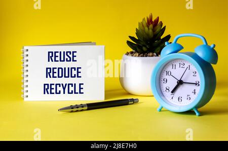 Reduce, reuse, recycle, repeat - environmental conservation and sustainable development concept - handwriting on notepad with cactus on yellow backgro Stock Photo