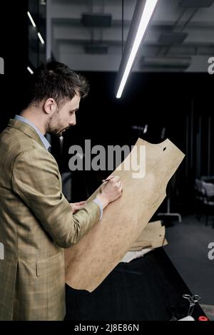 Tailor at work, drawing line on fabric with chalk Stock Photo - Alamy