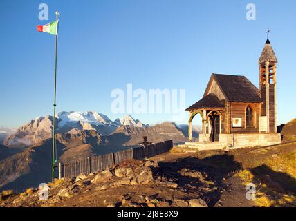 Small wooden church or chapel on the mountain top Col di Lana and Mount Marmolada, Alps Dolomites mountains, Italy Stock Photo