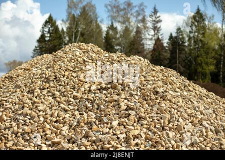 Small stone on construction site. Bunch of building material. Mountain of white rubble. Stock Photo