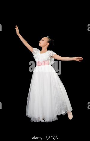 Girl ballet dancer in white long dress theatrical dancing on black background. Full length, studio shot. Part of photo series Stock Photo