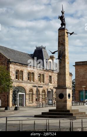 Inverness, Scotland - June 24, 2010: A high sandstone pillar topped with the unicorn statue in the centre of Falcon Square, beside the Eastgate Shoppi Stock Photo