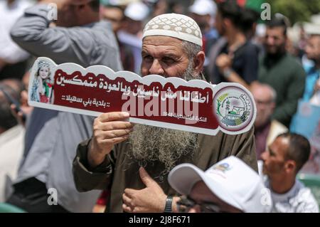 Gaza, Palestine. 15th May, 2022. A Palestinian holds a placard during a march to commemorate the 74th anniversary of the 'Nakba' in Gaza City. The anniversary of the Nakba falls on May 15 of every year, the day of the establishment of the State of Israel in 1948. (Photo by Yousef Masoud/SOPA Images/Sipa USA) Credit: Sipa USA/Alamy Live News Stock Photo