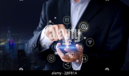 Hands of business man use mobile phone connect social media with internet. close up businessman working with smart phone in office with virtual icon d Stock Photo