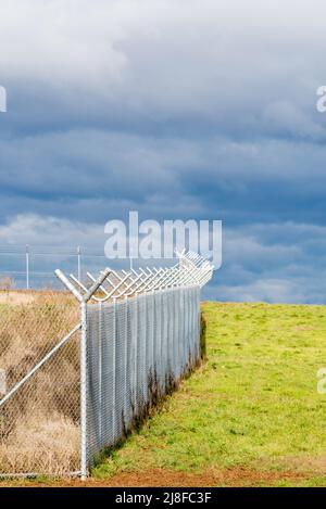 Grey skies and a high security perimeter fence surrounds par of the new Western Sydney (Nancy Bird Walton) International Airport due to open in 2026 Stock Photo