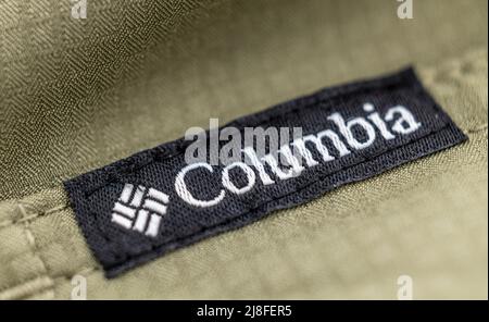 Denver, Colorado - May 10, 2022: Columbia brand label close-up on a gray cotton shirt Stock Photo