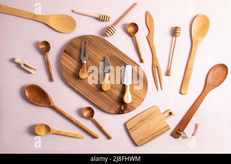various wooden and bamboo kitchen utensils are laid out on a pastel background. top view. flat lay Stock Photo
