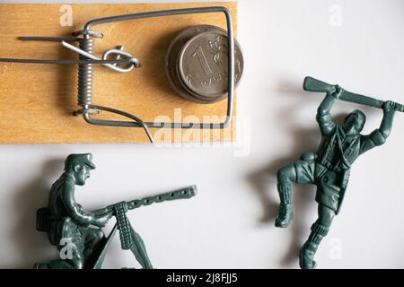 Russian rubles in a mouse trap and children's toy soldiers. Financial sanctions against Russia. The Russian economy and the ruble. Crisis in Russia 20 Stock Photo