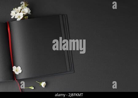 Cherry blossoms with an open black notebook Stock Photo