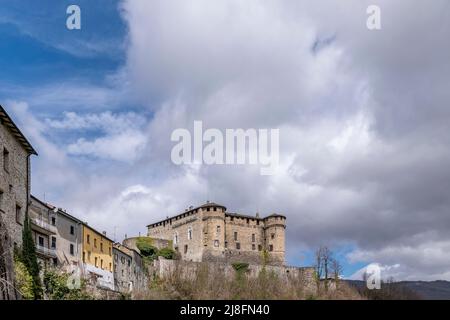 The ancient castle of Compiano, Parma, Italy, under a beautiful sky with white clouds Stock Photo