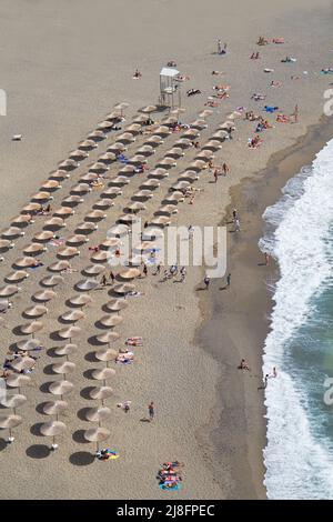 Aerial view of umbrellas on the beach, neatly lined up. Stock Photo