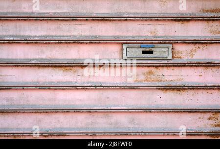 Letterbox on a weathered metal door Stock Photo