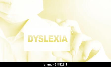 Dyslexia word on card. Doctor keeps a card with the name of the diagnosis dyslexia. Selective focus. Medical concept. Stock Photo